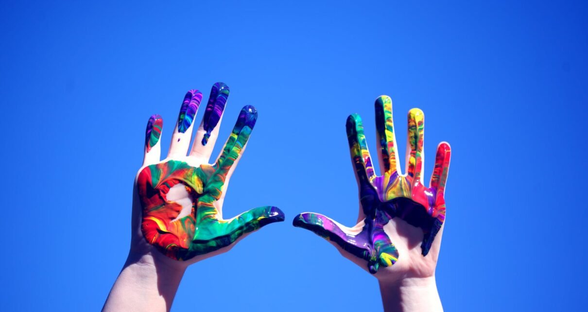 person s hands with paint